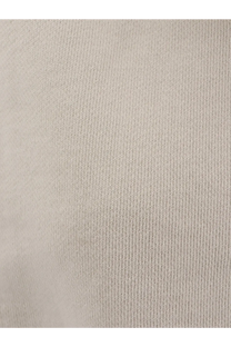 Beige ribbed knit fabric of entire studios women’s white cotton jogging trousers showcasing soft textured surface