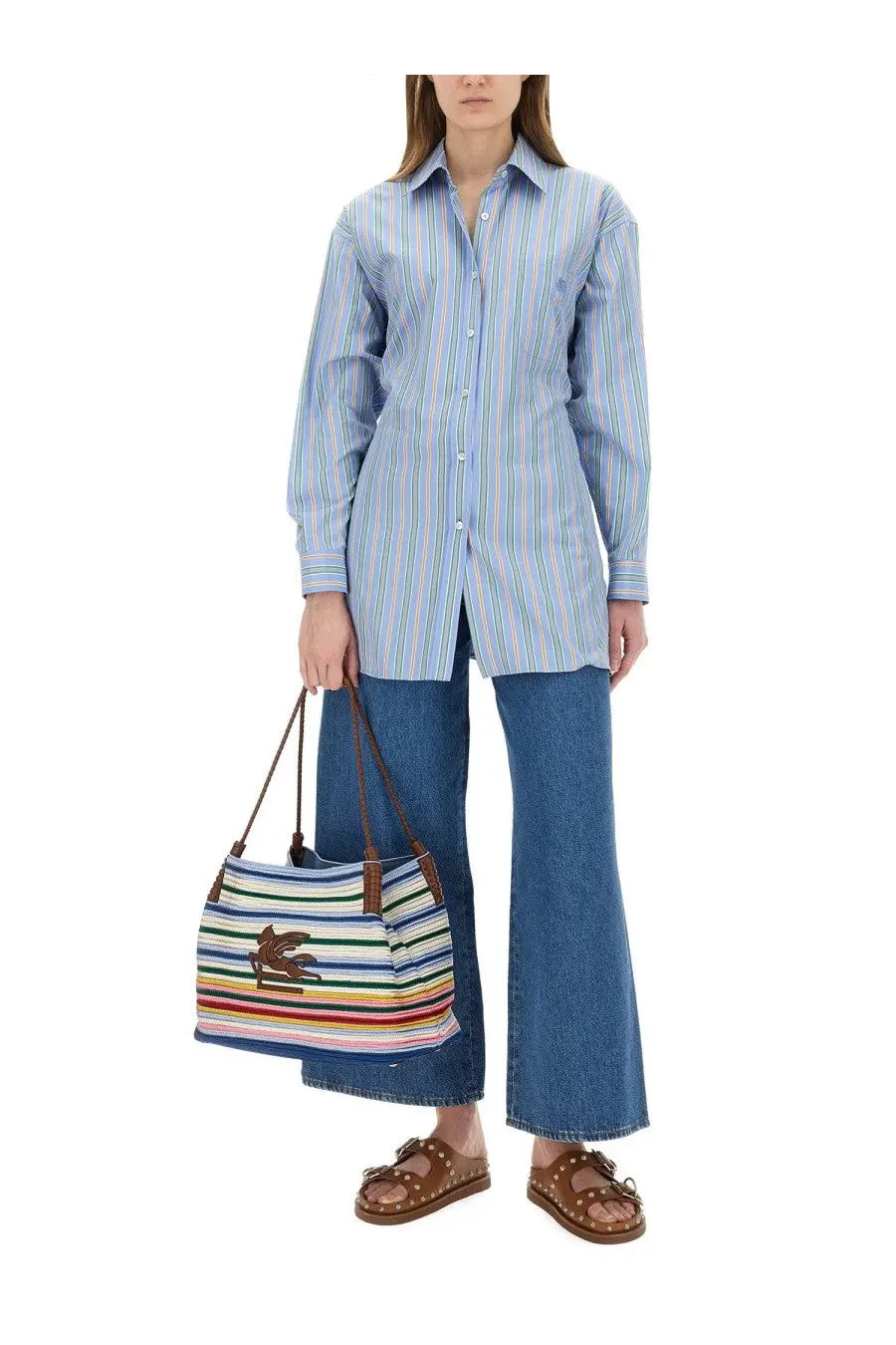 Multicolored striped canvas tote bag with brown leather handles and crocodile logo paired with etro womens blue jacquard shirt