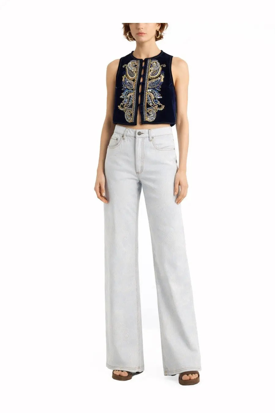 Etro women’s jeans blue paired with a navy velvet sleeveless crop top with gold and silver paisley embroidery