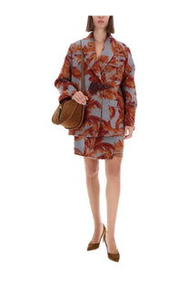 A woman wears an etro women’s wallet skirt two-piece with bold orange leaf patterns on muted blue-gray fabric