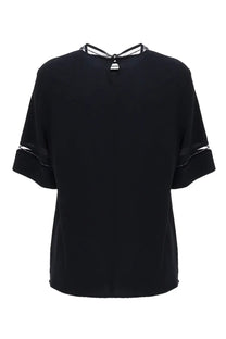 Fabiana Filippi women’s black short-sleeved blouse with satin finish and white lace trim at neckline and cuffs