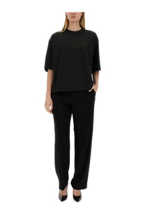 Black oversized short-sleeved top with relaxed fit and subtle seam detailing paired with fabiana filippi viscose pants