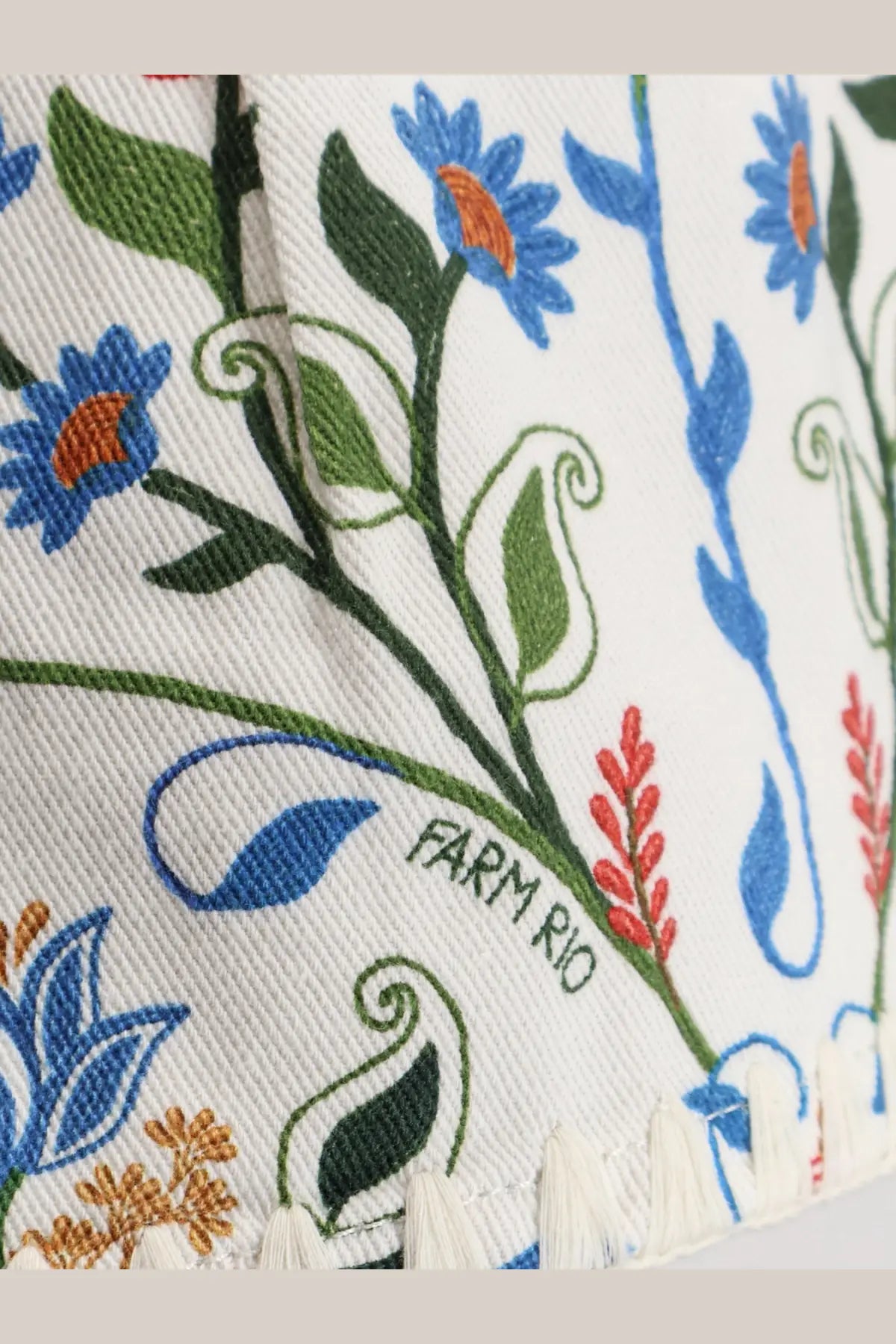 White cotton shorts with embroidered blue green and orange floral patterns and farm rio brand name visible