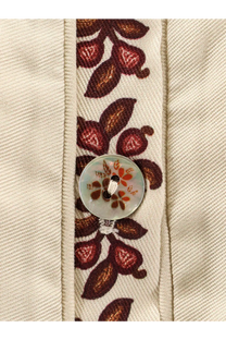 A translucent circular button with an orange and brown floral design on a farm rio women’s renata lyocell long dress beige