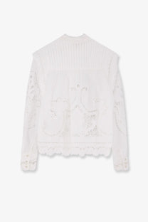 White lace blouse with delicate floral embroidery and ruffled hem made of organic cotton by FARM Rio