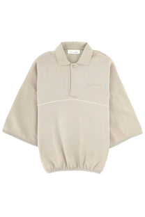 Fear of god essentials men’s felpa polo in beige with subtle white seam detail and elasticated hem for active wear