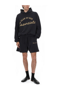 Fear of god essentials men’s felpa training 90s black hoodie and matching shorts with gold lettering