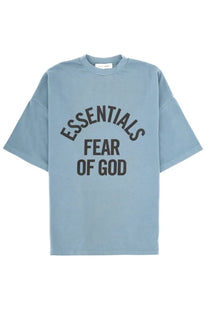 Light blue oversized Fear Of God Essentials men’s shirt with bold black lettering printed across the chest