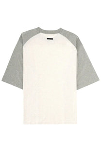 Fear of god essentials men’s minimalist two-tone raglan baseball shirt with cream body and heather gray sleeves