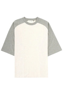 Fear of god essentials men’s minimalist two-tone raglan sleeve t-shirt in off-white and heather gray cotton blend