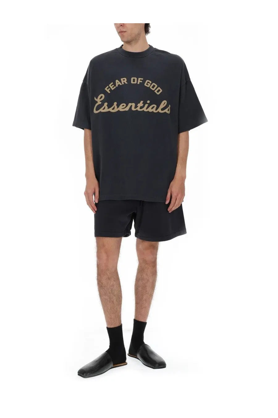 Black oversized Fear of God Essentials men’s shirt featuring gold foil lettering across the chest for training use