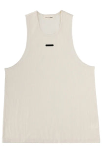 Cream-colored fear of god essentials men’s sleeveless tank top in cotton with a minimalist black stripe at chest