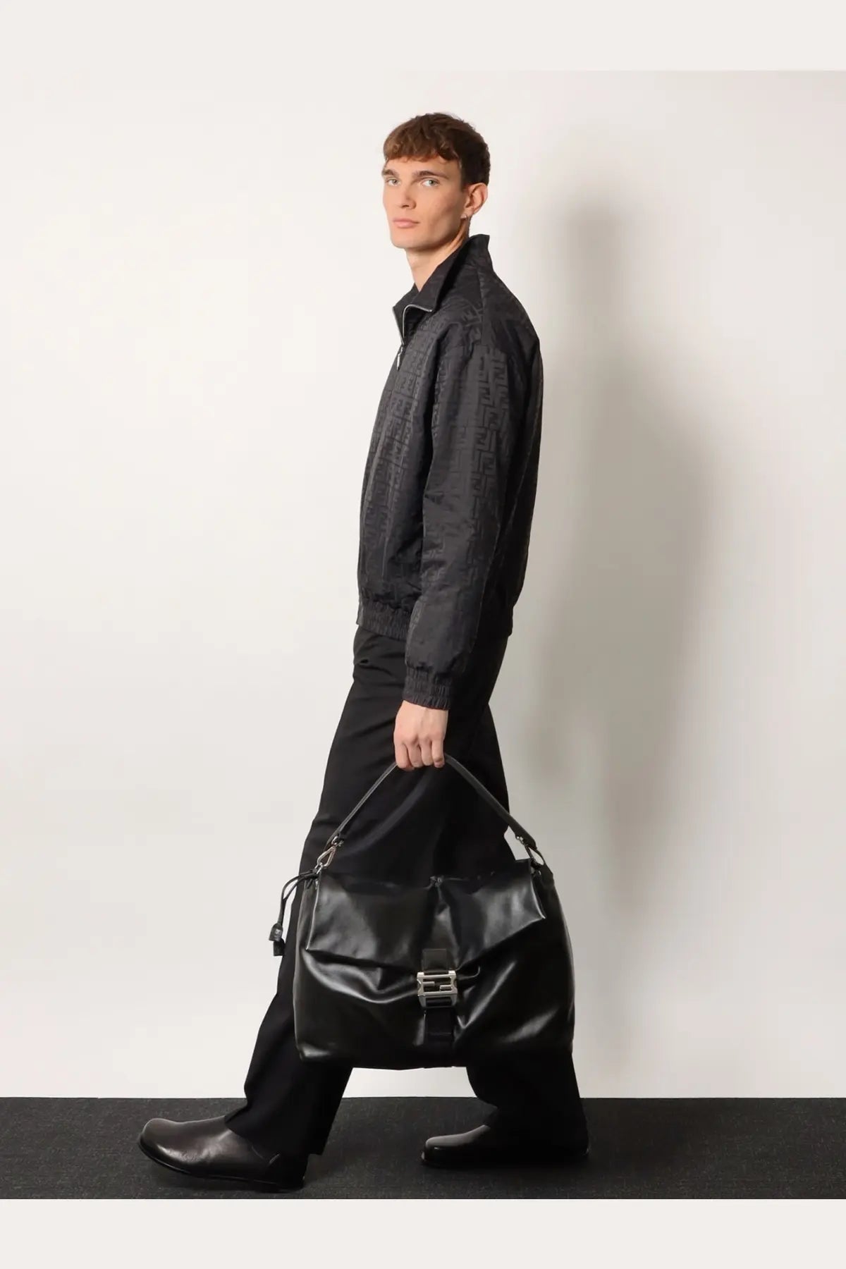 Black leather hobo bag with silver-toned buckle and adjustable strap by Fendi for men crossbody use