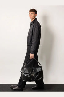 Black leather hobo bag with silver-toned buckle and adjustable strap by Fendi for men crossbody use