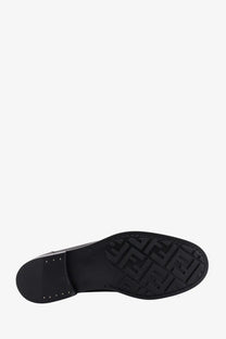 Black fendi men’s leather loafer sole with embossed ff logo pattern in black showing the back side of the shoe