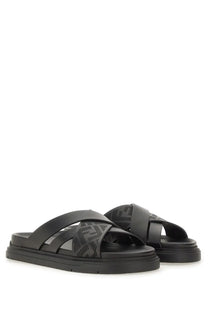 Fendi men’s black platform slide sandals with distinctive embossed pattern on leather straps