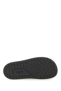 Black rubber sole of fendi men’s slide sandal with embossed fendi logo pattern and brand name visible