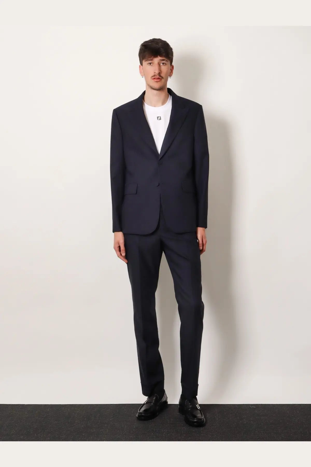 Navy blue tailored suit with single-breasted jacket and matching trousers made from wool with tonal stitching