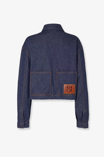 Back view of fendi women’s dark blue denim jacket with brown leather patch logo on the back