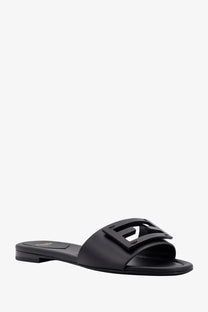 Fendi women’s black leather slide sandal with prominent logo buckle in a sleek baguette design