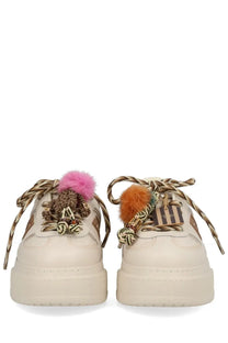 Cream-colored Fendi women’s platform sneakers with braided laces and colorful fuzzy pom-poms in beige