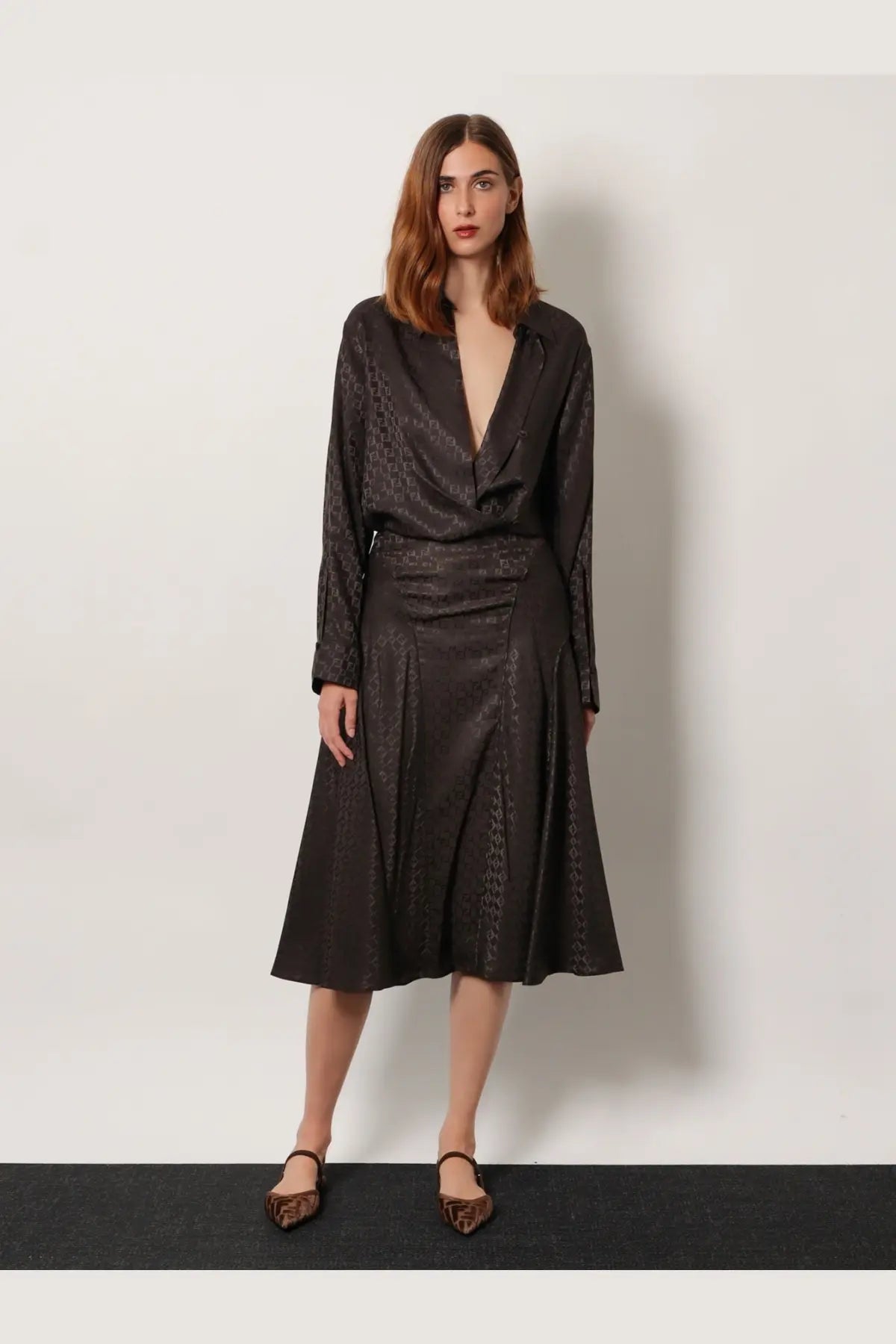 Black satin blouse with subtle leopard print pattern and long sleeves paired with fendi brown midi ff jacquard silk skirt