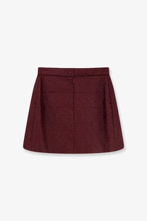 A burgundy Fendi women’s mini skirt in textured fabric featuring a repeating FF logo pattern