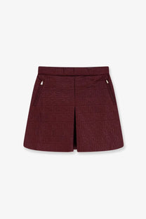 Burgundy Fendi quilted nylon mini skirt with textured geometric pattern and side zippers shown from the back side