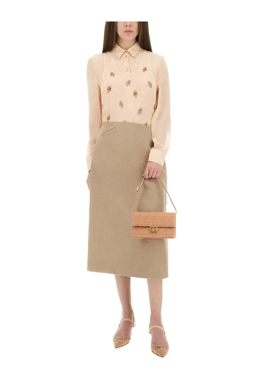 Tan leather mini fendi handbag with embossed logo and gold-tone hardware paired with beige waxed linen skirt