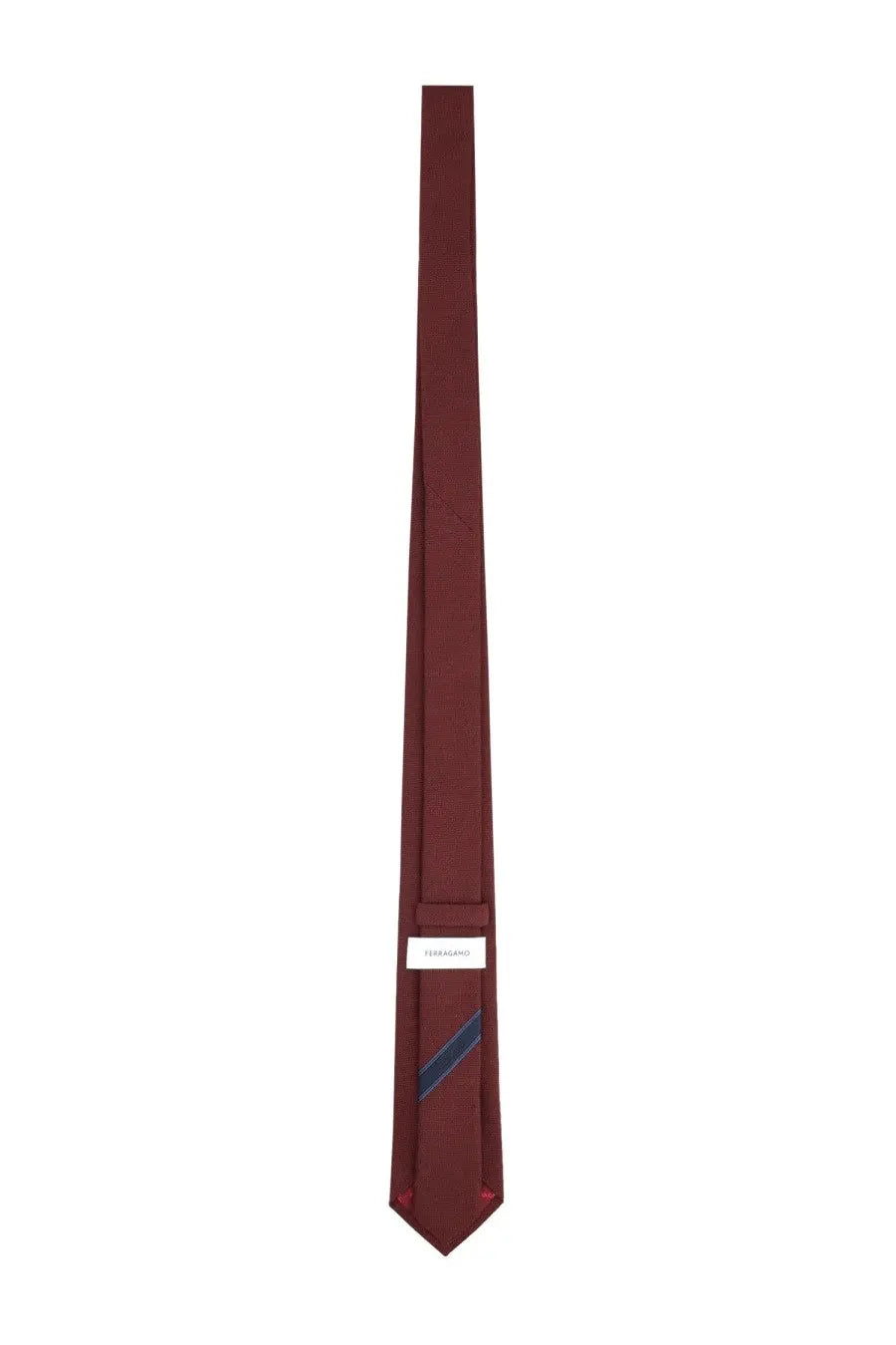 A sleek solid burgundy silk Ferragamo men’s cravatta with a subtle navy stripe and minimalist white brand label