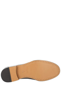 Tan leather sole with black rubber heel and stitched edges of ferragamo men’s moccasin gancini black back side