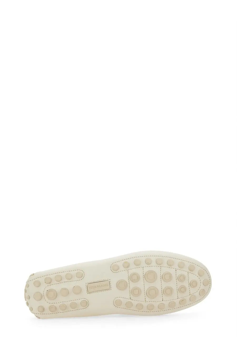 Cream-colored leather sole of ferragamo men’s white moccasin with circular tread pattern and small brand label
