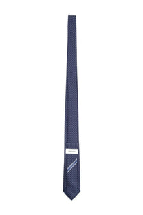 Ferragamo men’s silk tie blue with a subtle pattern of tiny white dots and brand label at the base