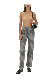 Gray camouflage-patterned wide-leg jeans paired with fiorucci women’s beige tulle tops for a stylish casual look