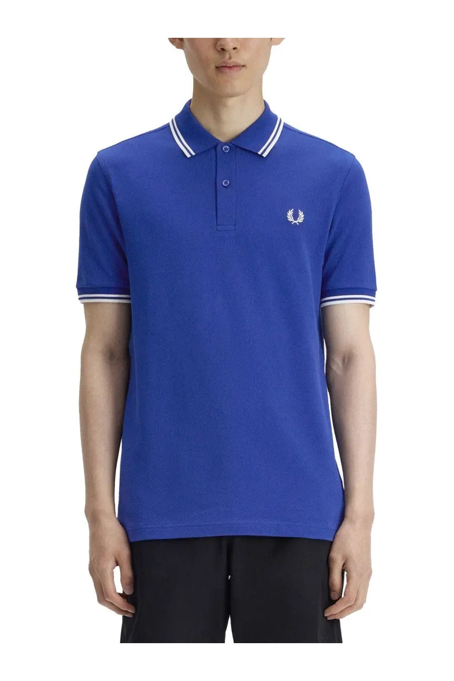 Royal blue Fred Perry men’s polo shirt with white trim and embroidered laurel wreath logo on chest