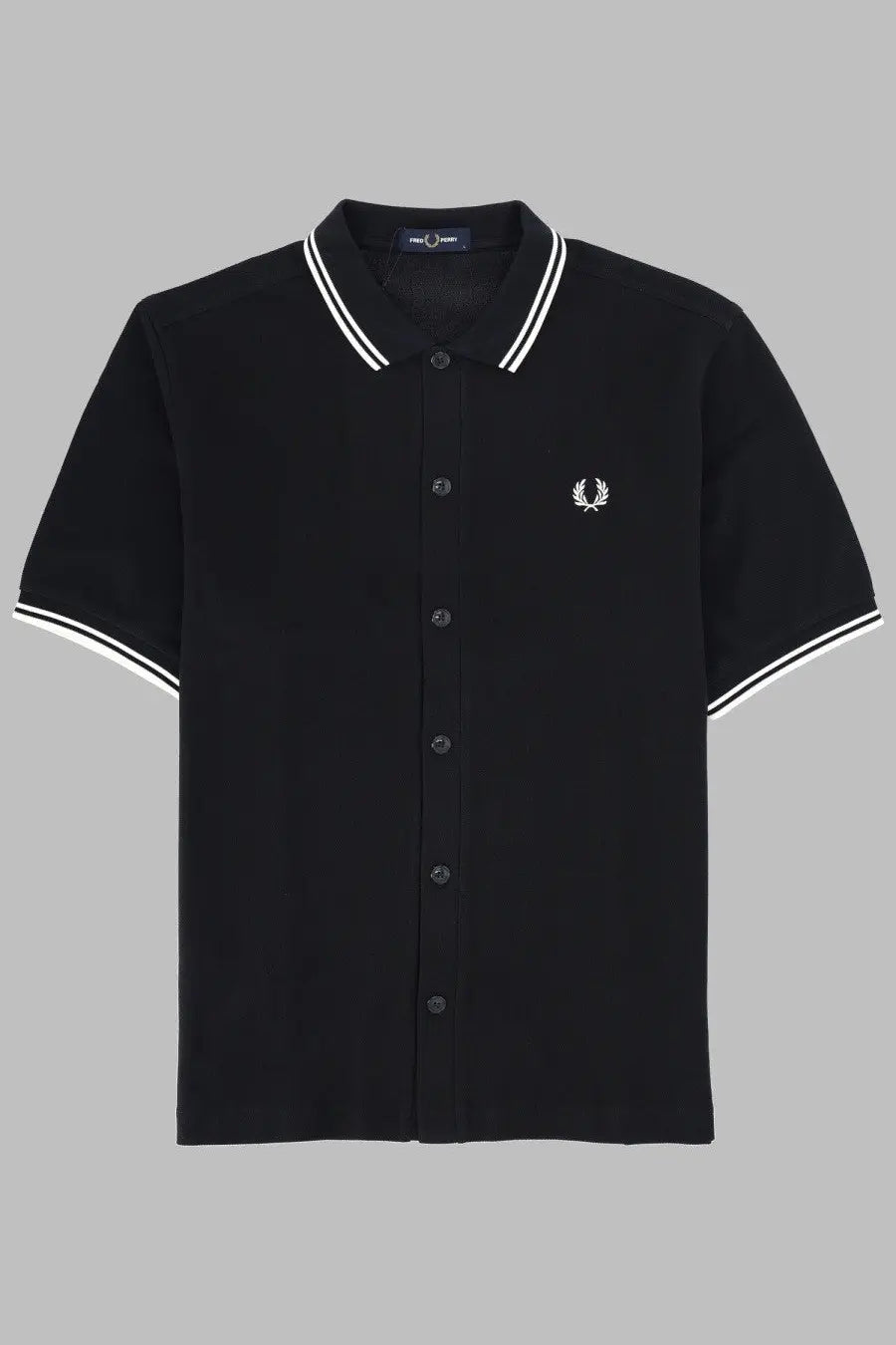 Black fred perry men’s polo shirt with white collar and sleeve trim featuring small embroidered laurel wreath logo