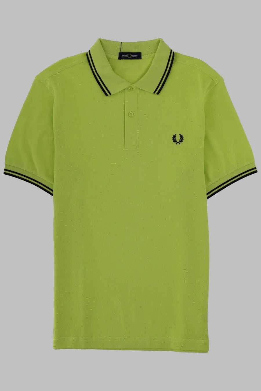 Bright lime green fred perry men’s polo con green shirt with black collar trim and embroidered laurel wreath logo