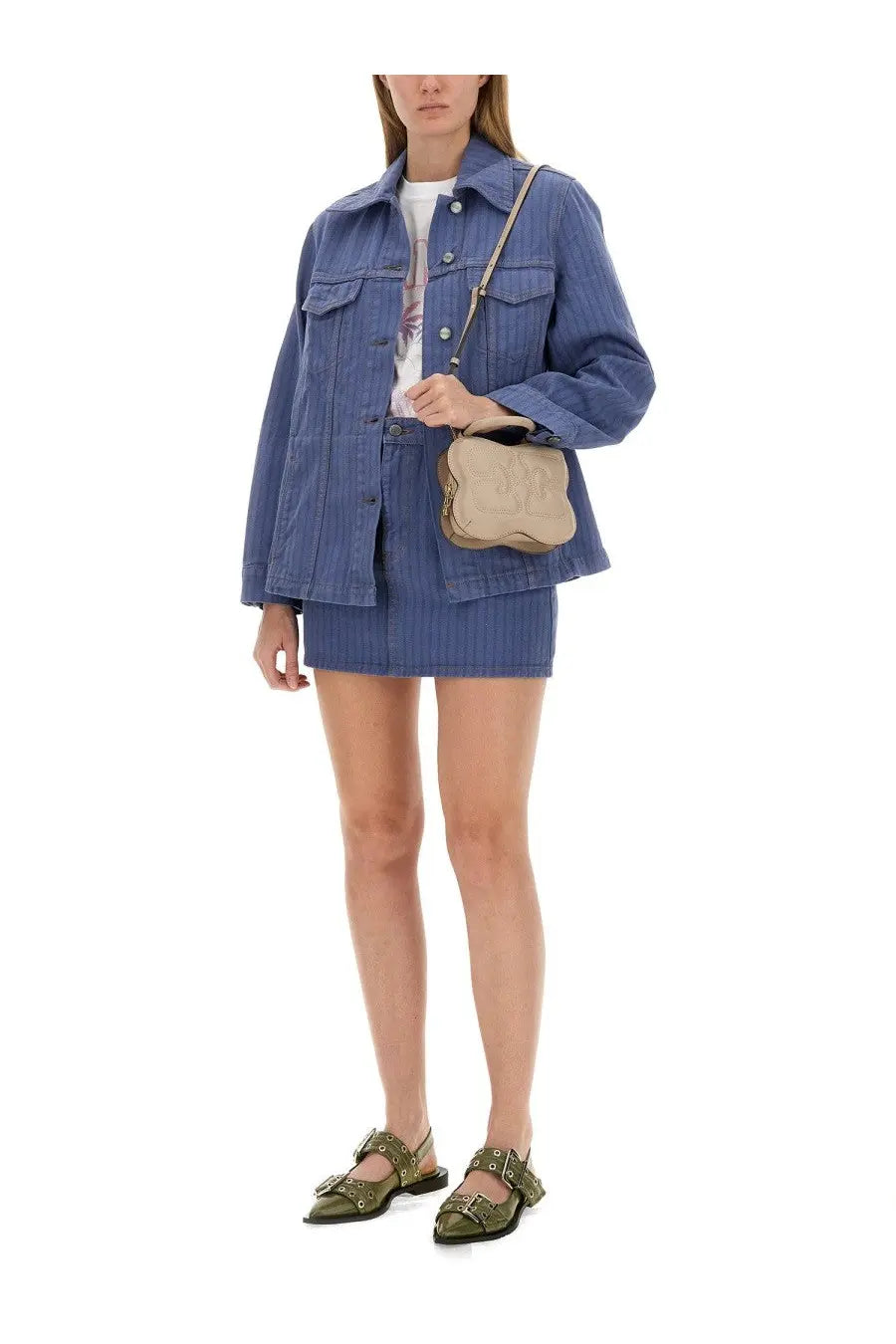 Beige leather crossbody bag with soft rounded shape and subtle stitching details paired with ganni women’s blue denim jacket