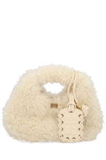 Cream-colored fluffy faux fur hobo bag by Ganni with matching leather tag and gold-tone hardware in white