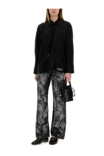 Black leather bucket bag with gold-tone hardware and drawstring top paired with ganni women’s jacquard satin shirt black