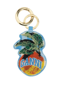 A vibrant embroidered keychain with a tropical palm tree on a multicolor patchwork background by Ganni