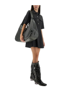 Black leather hobo bag with drawstring top and adjustable shoulder strap shown with ganni womens mini dress grey