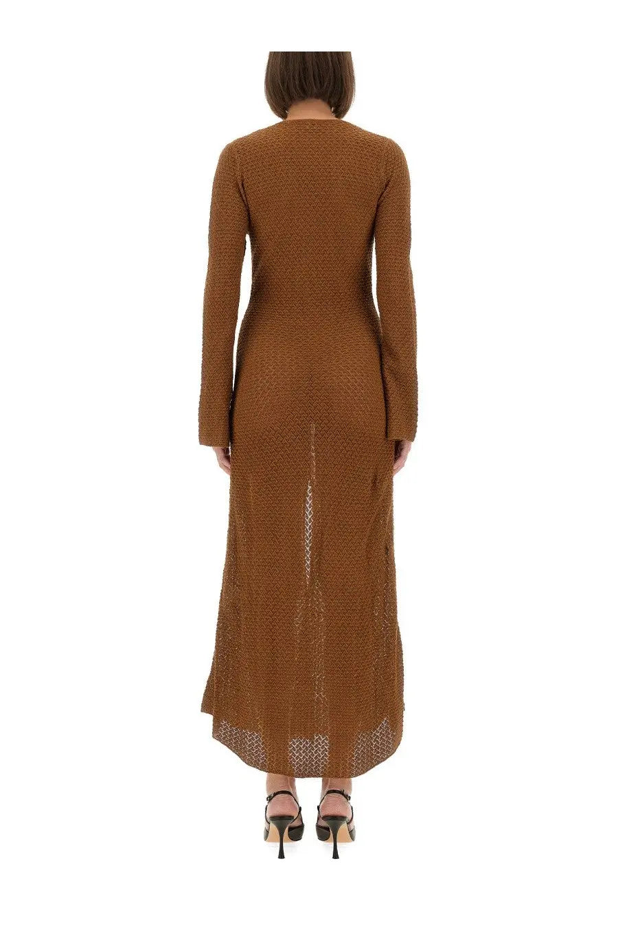 The Garment women’s long dress Tanzania bronze is a brown knitted maxi dress with a textured pattern and asymmetrical hemline