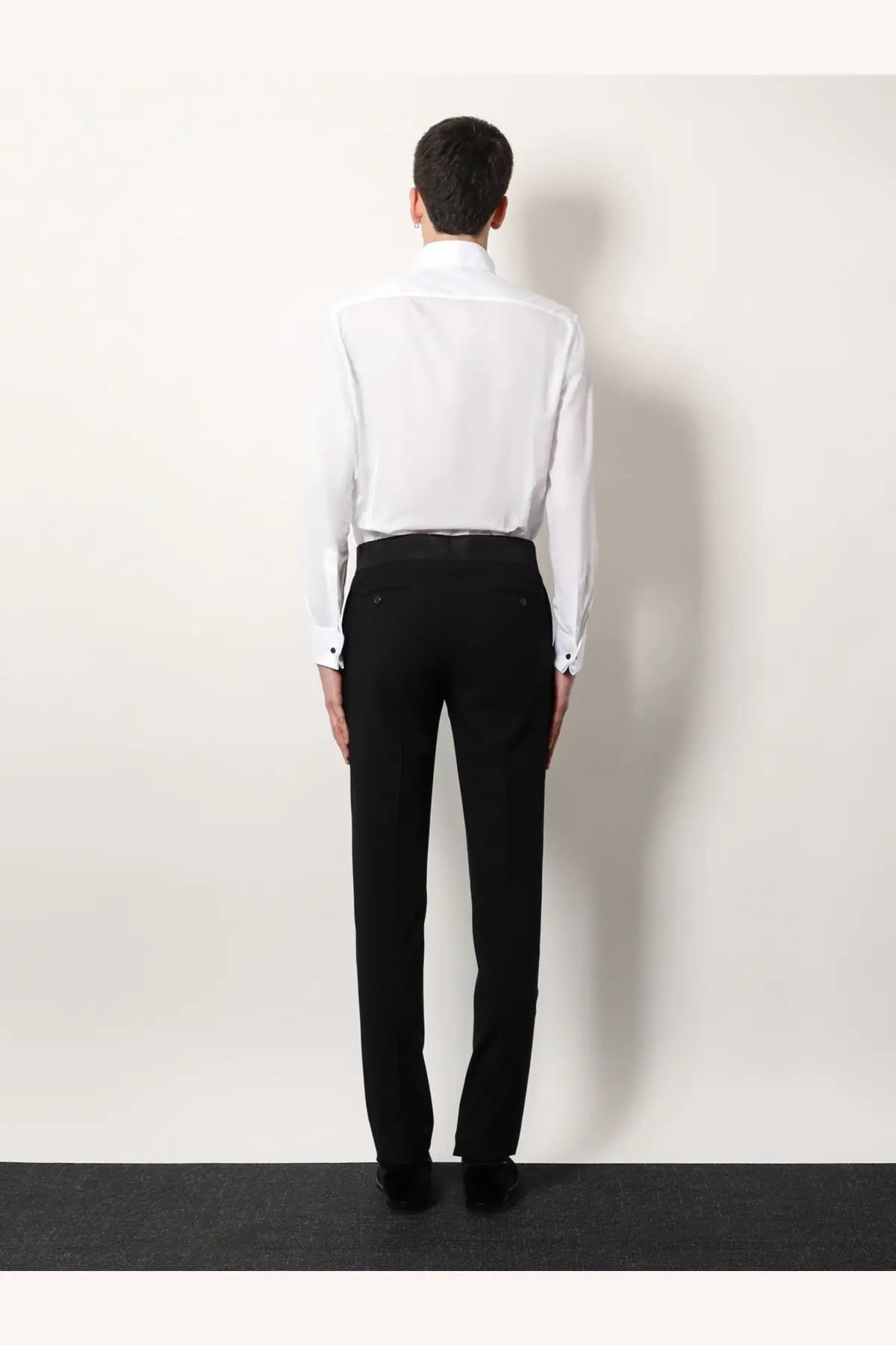 Black tailored trousers with a sleek formal cut and subtle creases paired with giorgio armani men’s white cotton shirt