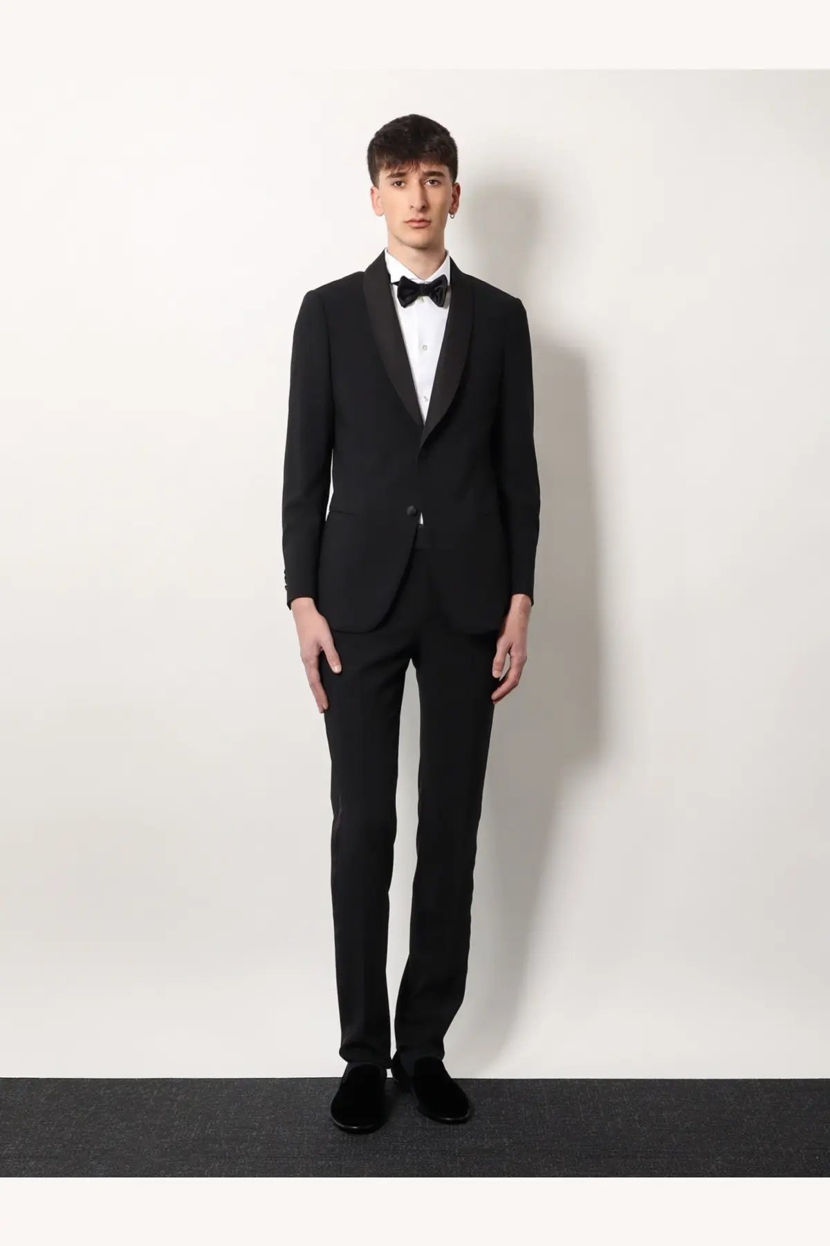 Black tuxedo suit with satin lapels and matching bow tie styled with a Giorgio Armani men’s white cotton shirt