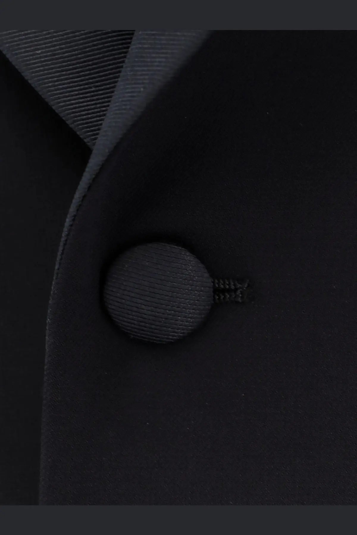 Black textured fabric button with subtle ribbed pattern on Giorgio Armani men’s virgin wool tuxedo blue