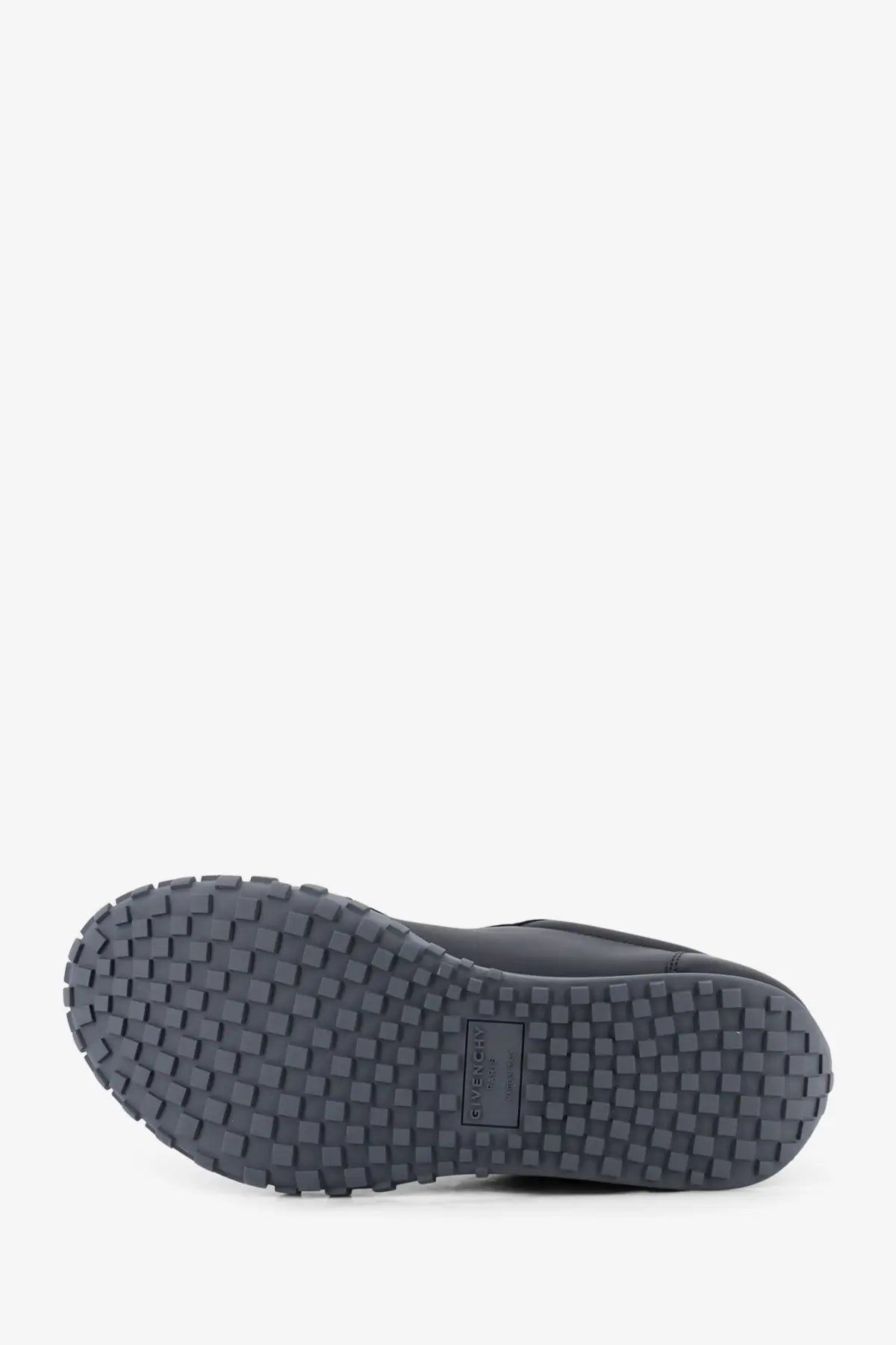 Dark gray rubber sole with textured grid pattern and givenchy logo on givenchy men’s leather sneakers black