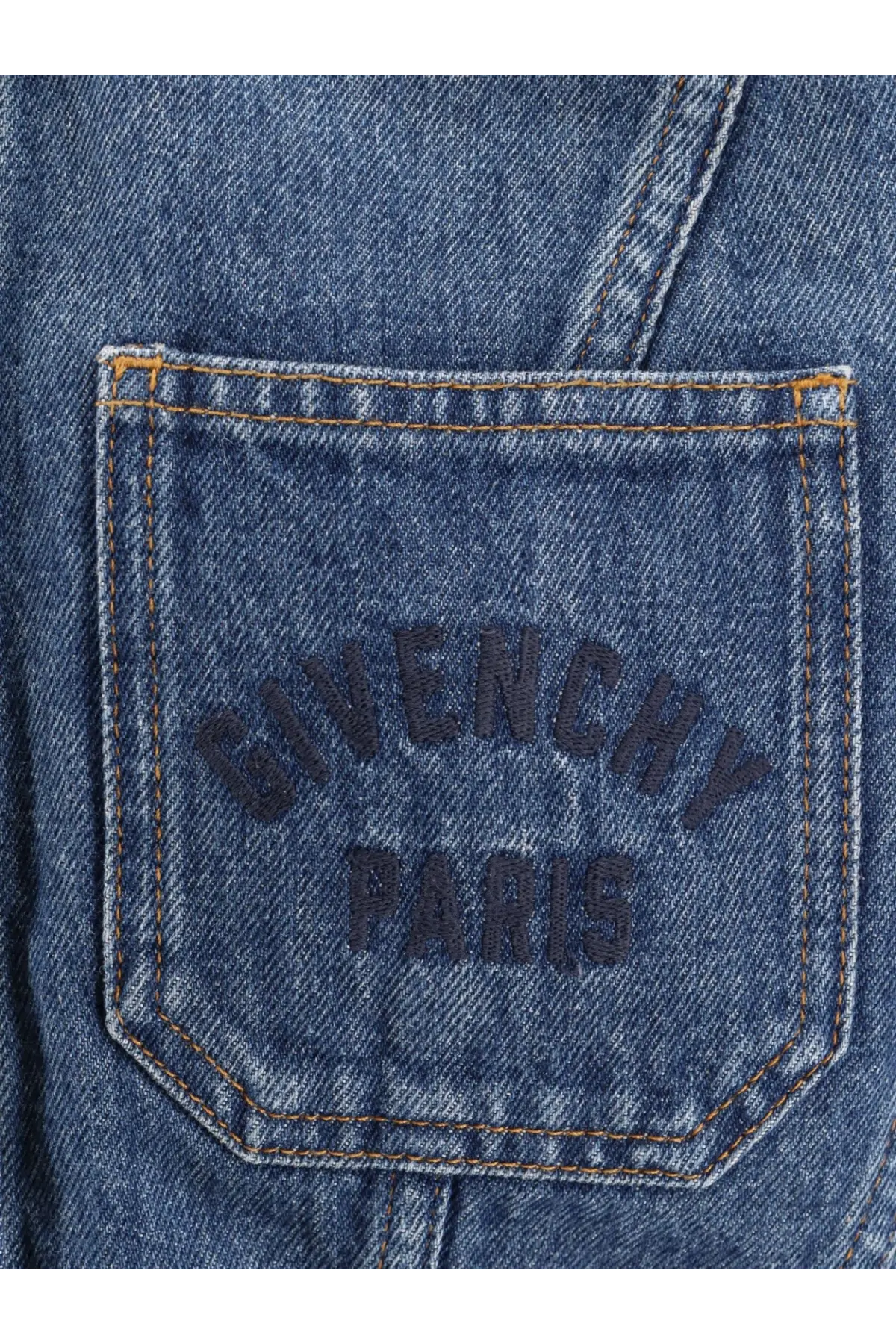 Blue denim pocket of Givenchy women’s denim jacket featuring dark blue embroidered logo and tan contrasting stitching