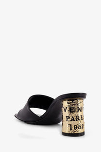 Givenchy women’s black leather mule sandal with gold foil block heel featuring veneti paris 1952 lettering