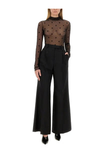 Givenchy women’s pantsuit black featuring a black sheer long-sleeved top with high neckline and dark brown polka dots